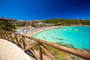 Spiaggia di Rena Bianca beach with red rocks and azure clear water, Santa Terasa Gallura, Costa Smeralda, Sardinia, Italy